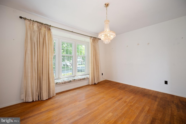 11 Whitekirk Dr, Wilmington, DE 19808 - spare room with baseboards, an inviting chandelier, and light wood-style floors