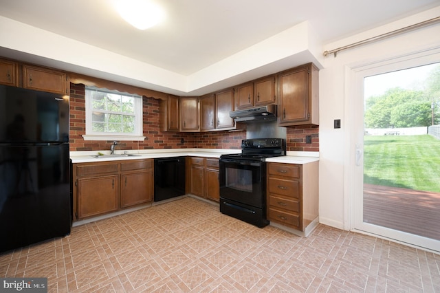 11 Whitekirk Dr, Wilmington, DE 19808 - kitchen featuring brown cabinets, a sink, light countertops, under cabinet range hood, and black appliances