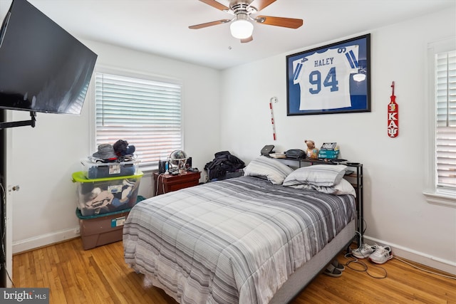 4311 Chatham Rd, Baltimore, MD 21207 - bedroom featuring baseboards, light wood-style floors, multiple windows, and a ceiling fan