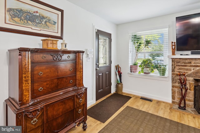 4311 Chatham Rd, Baltimore, MD 21207 - entryway featuring wood finished floors, baseboards, and a fireplace