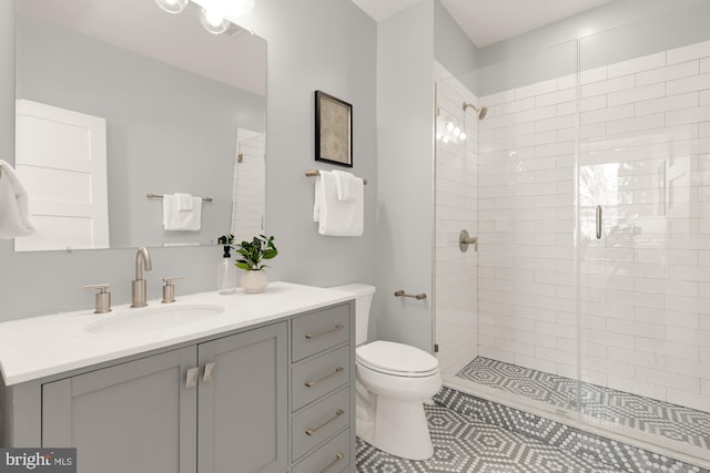 full bathroom with vanity, toilet, tile patterned flooring, and a stall shower