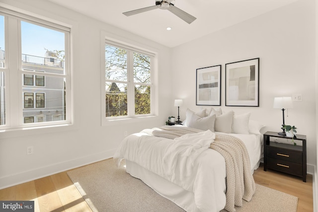 bedroom featuring light wood-style floors, recessed lighting, baseboards, and a ceiling fan