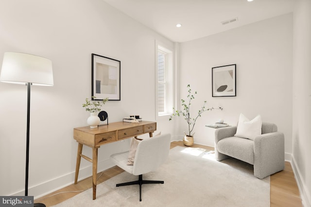 office area with baseboards, recessed lighting, light wood-style floors, and visible vents