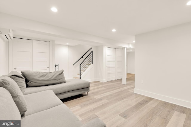 living area featuring recessed lighting, stairs, baseboards, and light wood-style floors