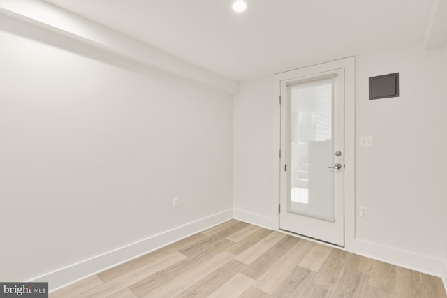 unfurnished room with recessed lighting, baseboards, and light wood-style flooring