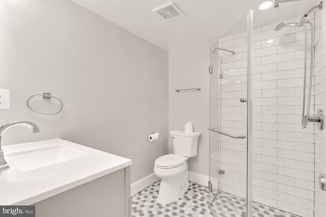 full bath with visible vents, a shower stall, vanity, baseboards, and toilet
