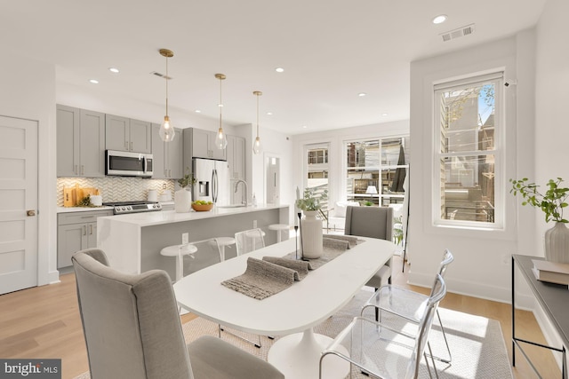 dining area featuring recessed lighting, visible vents, and light wood-style floors