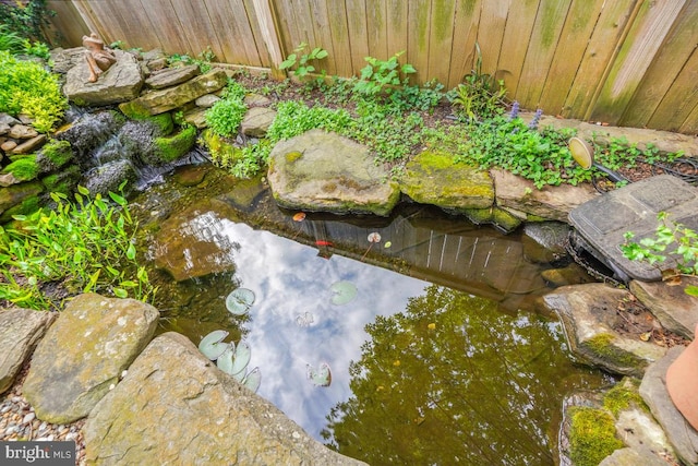 217 Hart Rd, Gaithersburg, MD 20878 - exterior details featuring fence and a small pond