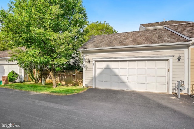 217 Hart Rd, Gaithersburg, MD 20878 - garage featuring aphalt driveway and fence