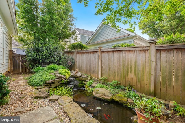 217 Hart Rd, Gaithersburg, MD 20878 - view of yard with a fenced backyard and a garden pond