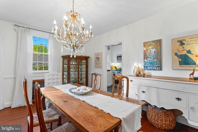 110 Murdock Rd, Baltimore, MD 21212 - dining space with a chandelier, wood finished floors, and baseboards