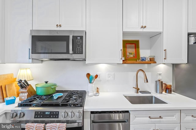 110 Murdock Rd, Baltimore, MD 21212 - kitchen with appliances with stainless steel finishes, a sink, white cabinets, and light countertops