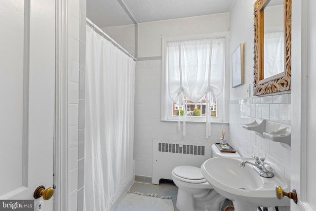 110 Murdock Rd, Baltimore, MD 21212 - full bath featuring radiator, tile walls, toilet, a sink, and a shower with shower curtain