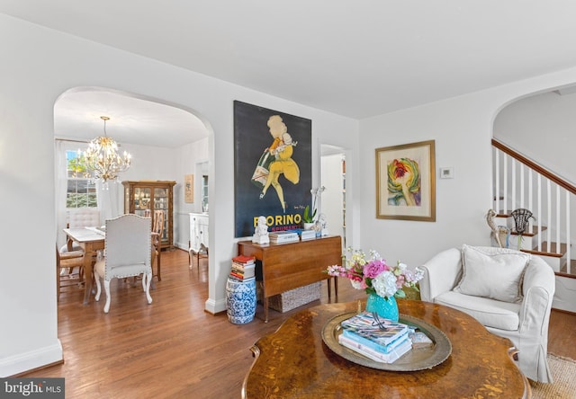 110 Murdock Rd, Baltimore, MD 21212 - dining room with arched walkways, a chandelier, wood finished floors, and baseboards