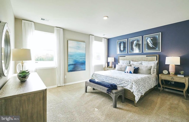 carpeted bedroom featuring baseboards and visible vents