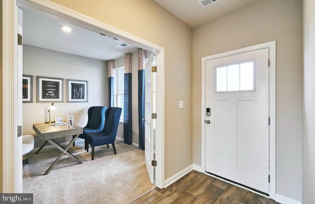 foyer entrance with baseboards, visible vents, and dark wood finished floors