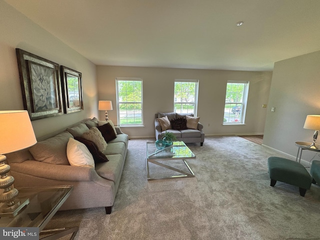 living area with a wealth of natural light, carpet floors, and baseboards