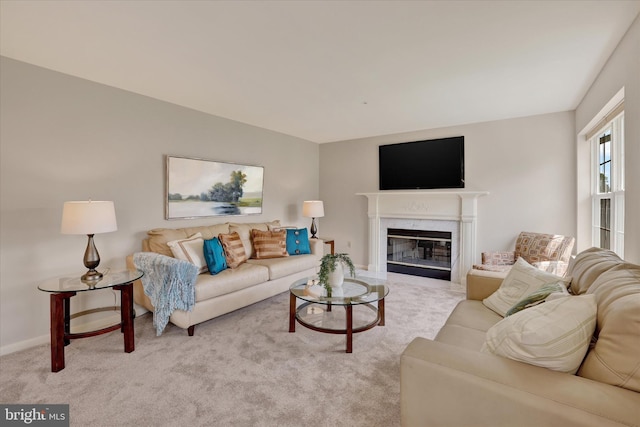 living area with carpet flooring, a fireplace, and baseboards