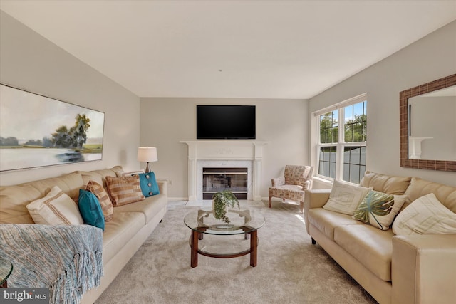 living area featuring a premium fireplace and carpet