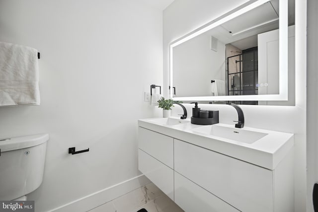 1372 Bryant St NE Unit 201, Washington, DC 20018 - bathroom featuring baseboards, a sink, marble finish floor, and double vanity