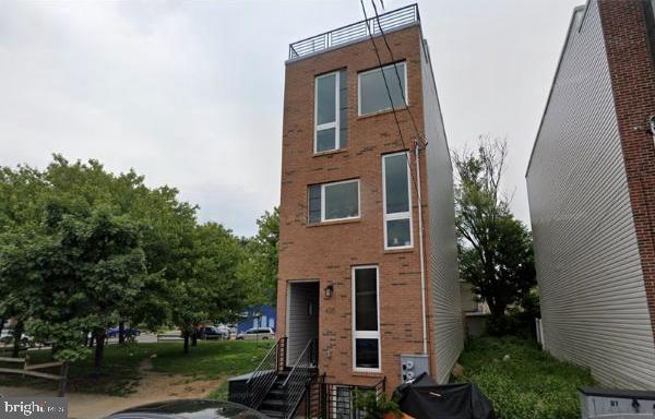 rear view of property featuring brick siding