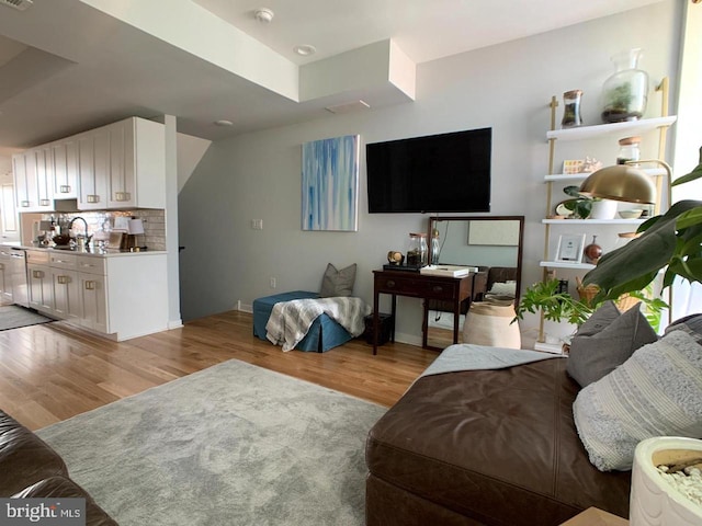 living room featuring baseboards and light wood-style flooring