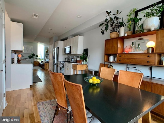 dining space featuring visible vents, recessed lighting, and light wood-style flooring