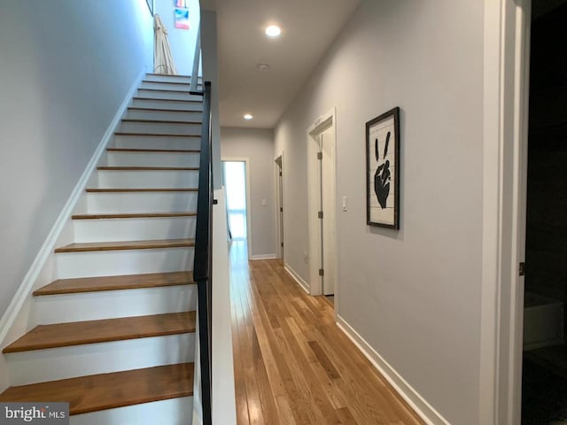 stairs featuring baseboards, recessed lighting, and wood finished floors