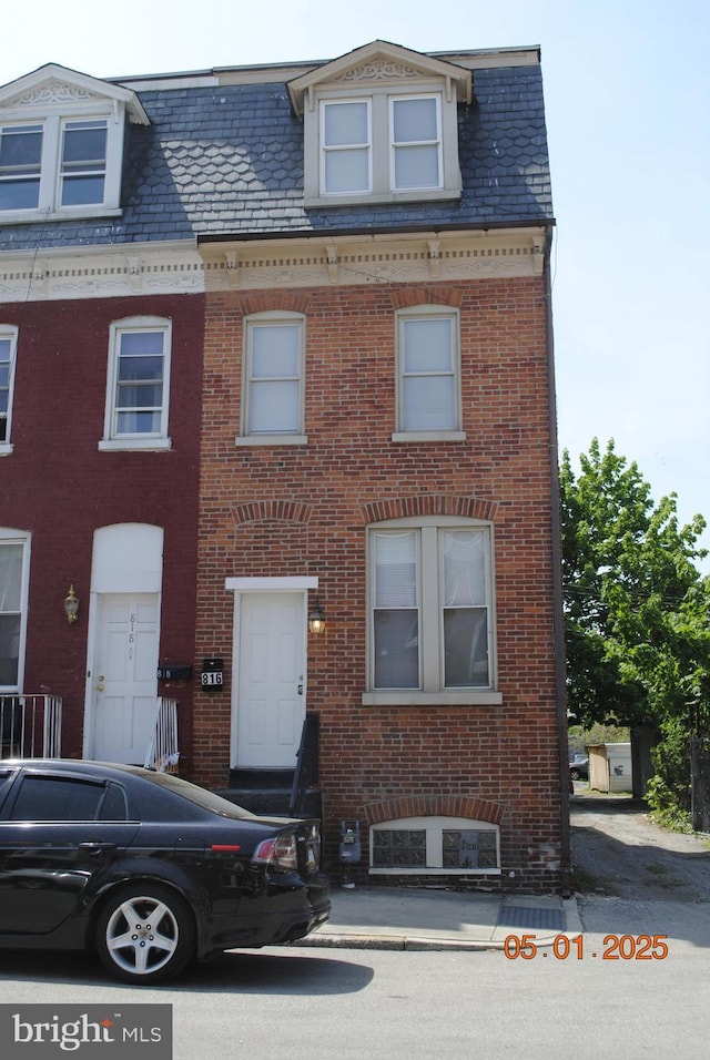 816 S Beaver St, York, PA 17403 - view of front facade with brick siding, mansard roof, and a high end roof