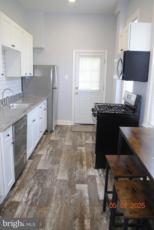 816 S Beaver St, York, PA 17403 - kitchen featuring black range with gas stovetop, dishwasher, a sink, dark wood-type flooring, and white cabinets
