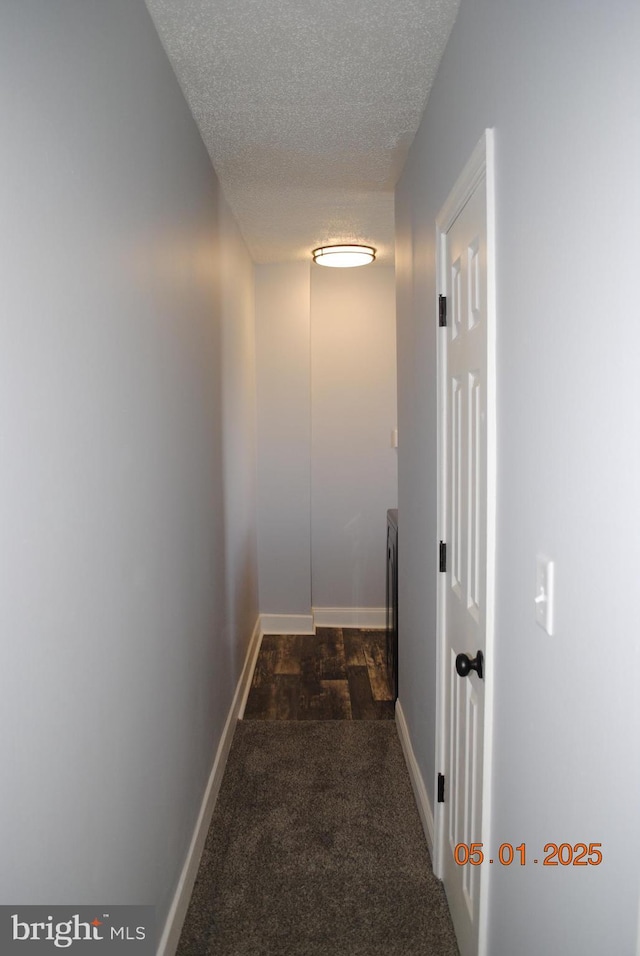 816 S Beaver St, York, PA 17403 - corridor with dark colored carpet, a textured ceiling, and baseboards