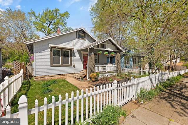 2610 Hamlin St NE, Washington, DC 20018 - bungalow featuring covered porch, a chimney, and a fenced front yard