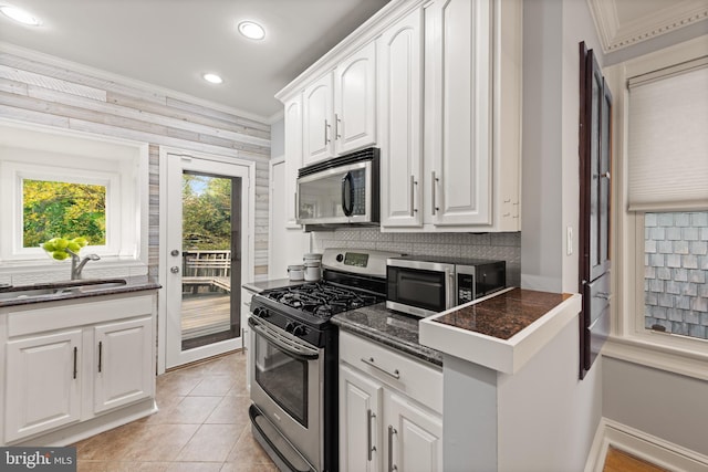 2610 Hamlin St NE, Washington, DC 20018 - kitchen with stainless steel appliances, crown molding, a sink, tasteful backsplash, and white cabinetry