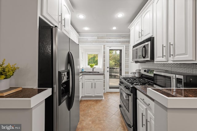 2610 Hamlin St NE, Washington, DC 20018 - kitchen featuring appliances with stainless steel finishes, white cabinetry, recessed lighting, tasteful backsplash, and light tile patterned floors