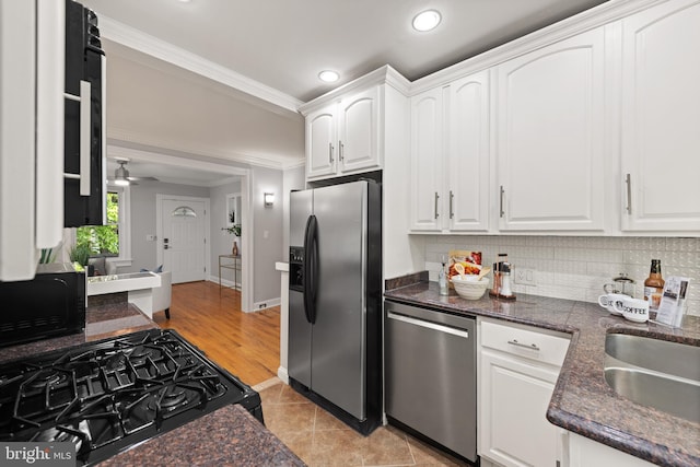 2610 Hamlin St NE, Washington, DC 20018 - kitchen with black appliances, white cabinetry, ornamental molding, tasteful backsplash, and recessed lighting