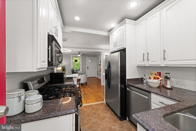 2610 Hamlin St NE, Washington, DC 20018 - kitchen featuring stainless steel appliances, white cabinets, ornamental molding, backsplash, and recessed lighting