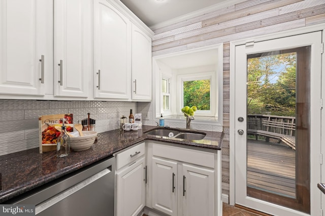 2610 Hamlin St NE, Washington, DC 20018 - kitchen with stainless steel dishwasher, a sink, white cabinets, decorative backsplash, and crown molding