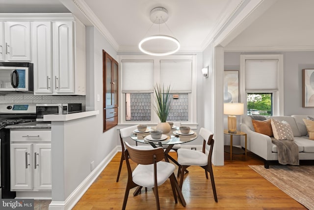 2610 Hamlin St NE, Washington, DC 20018 - dining area with light wood finished floors, crown molding, and baseboards