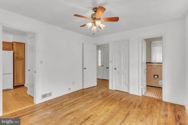 1529 Red Oak Dr, Silver Spring, MD 20910 - unfurnished bedroom with freestanding refrigerator, light wood-style flooring, ensuite bathroom, and baseboards