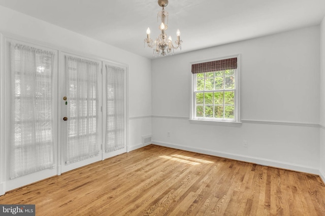 1529 Red Oak Dr, Silver Spring, MD 20910 - unfurnished room with a chandelier, baseboards, and wood finished floors