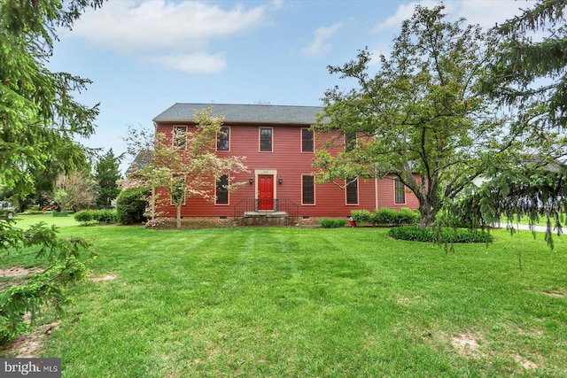 rear view of property with a yard and crawl space