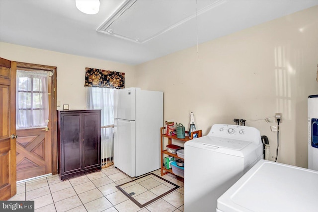 washroom with light tile patterned floors, laundry area, attic access, and washer / clothes dryer