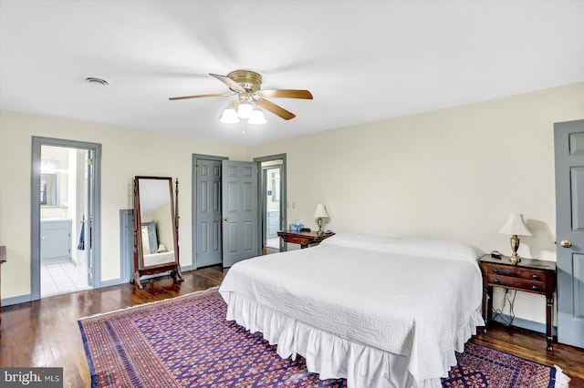 bedroom with baseboards, a ceiling fan, connected bathroom, and wood finished floors