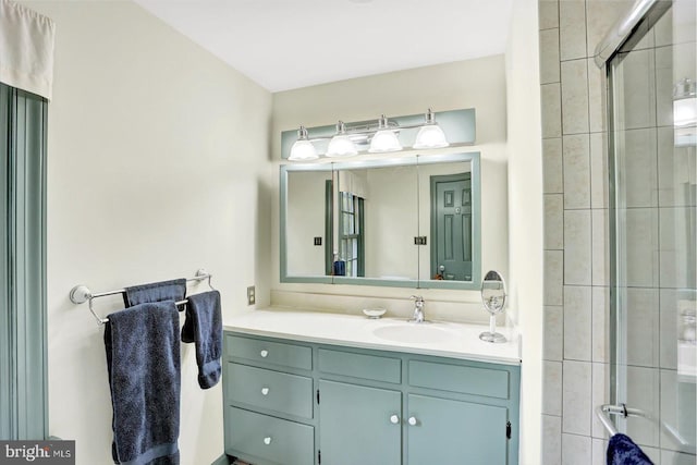 bathroom with vanity and a tile shower