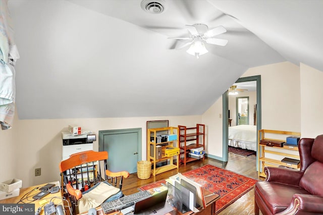living room with ceiling fan, vaulted ceiling, wood finished floors, and visible vents