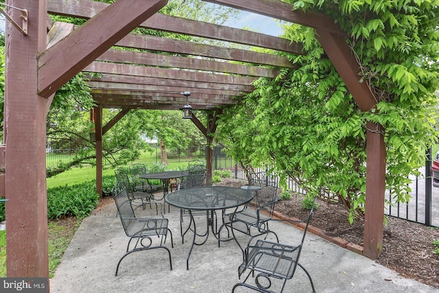 view of patio featuring a pergola, fence, and outdoor dining space