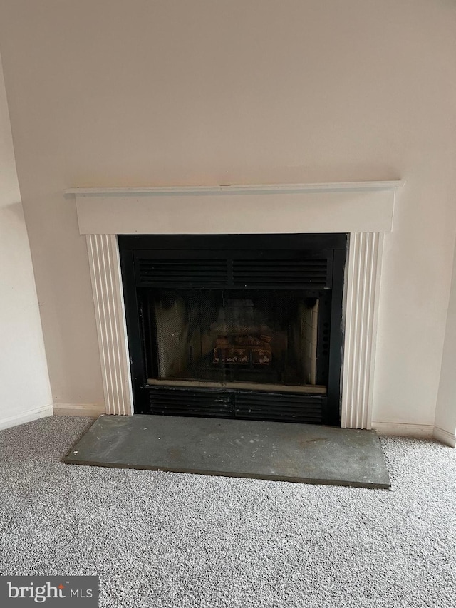 216 Highland Blvd Unit 77, New Castle, DE 19720 - detailed view of a fireplace, carpet floors, and baseboards