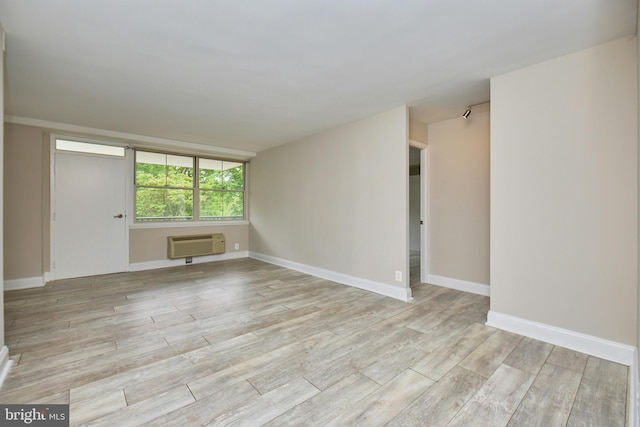 2030 N Adams St N Unit 507, Arlington, VA 22201 - empty room with a wall mounted air conditioner, light wood-style flooring, and baseboards