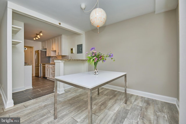 2030 N Adams St N Unit 507, Arlington, VA 22201 - dining space with wood finished floors, baseboards, electric panel, and rail lighting