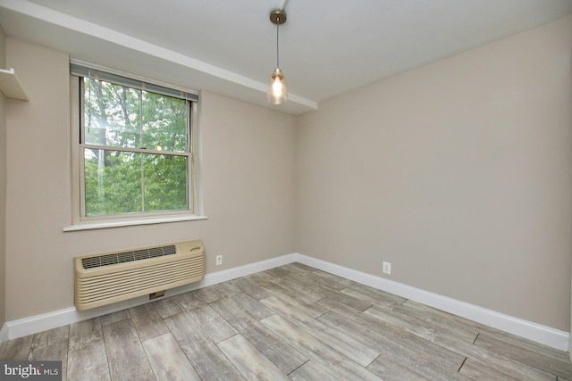 2030 N Adams St N Unit 507, Arlington, VA 22201 - unfurnished room with a wall unit AC, wood finished floors, and baseboards
